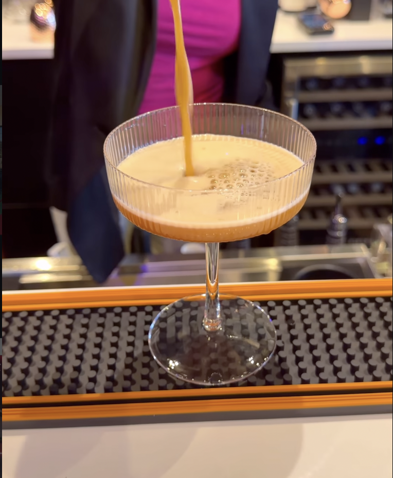 Espresso cocktail being poured into a ribbed coupe glass at Babe